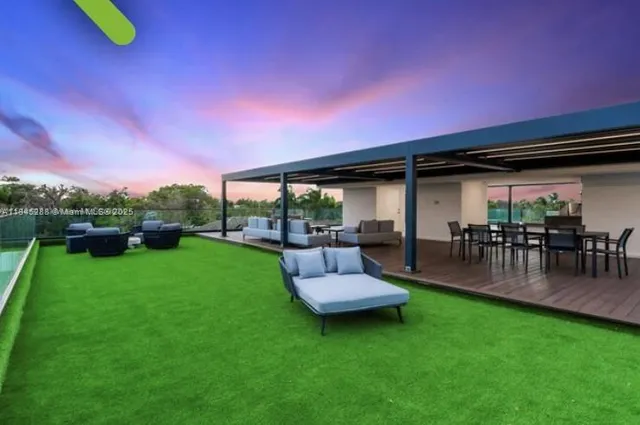 a living room with furniture and kitchen view