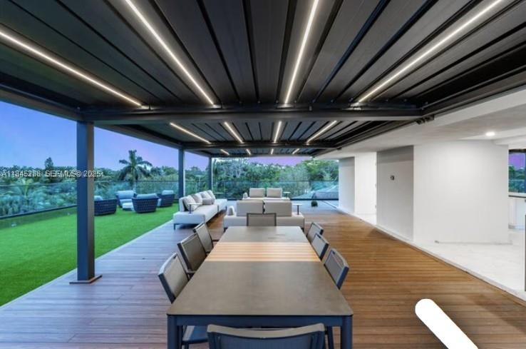 1248 Northeast 89th Street Miami, FL 33138 - Photo 13 of 66 a view of a patio with table and chairs potted plants with wooden floor and fence