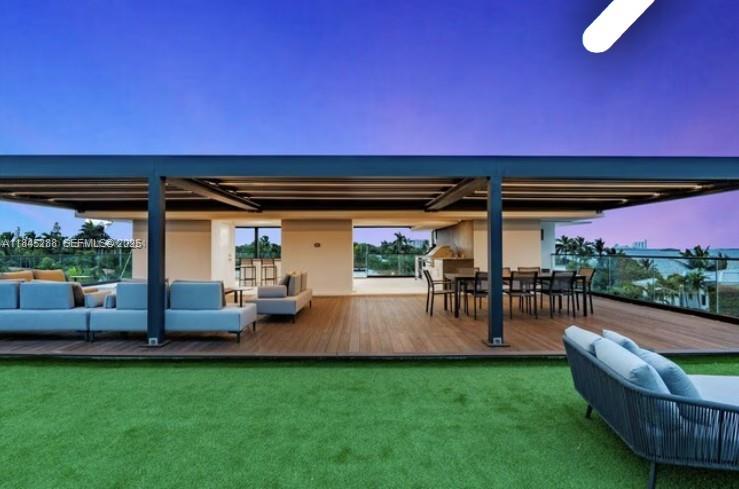 1248 Northeast 89th Street Miami, FL 33138 - Photo 14 of 66 a view of a porch with furniture and a yard