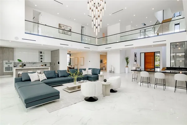 a kitchen with stainless steel appliances granite countertop a sink and a refrigerator