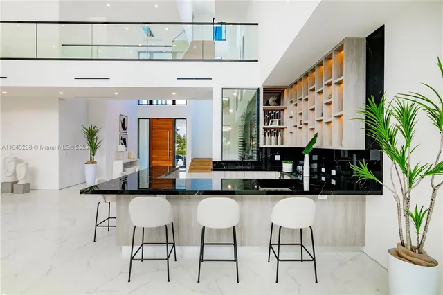 a kitchen with stainless steel appliances kitchen island granite countertop a sink and cabinets