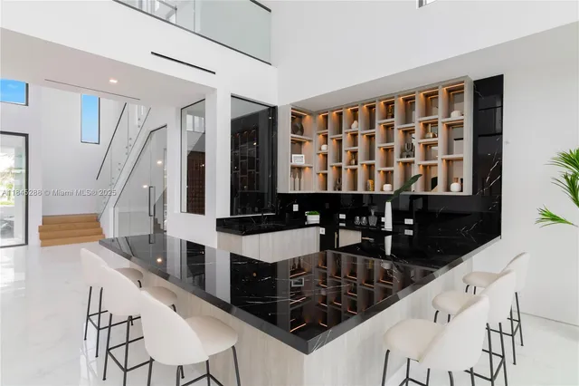 a living room with furniture and large windows