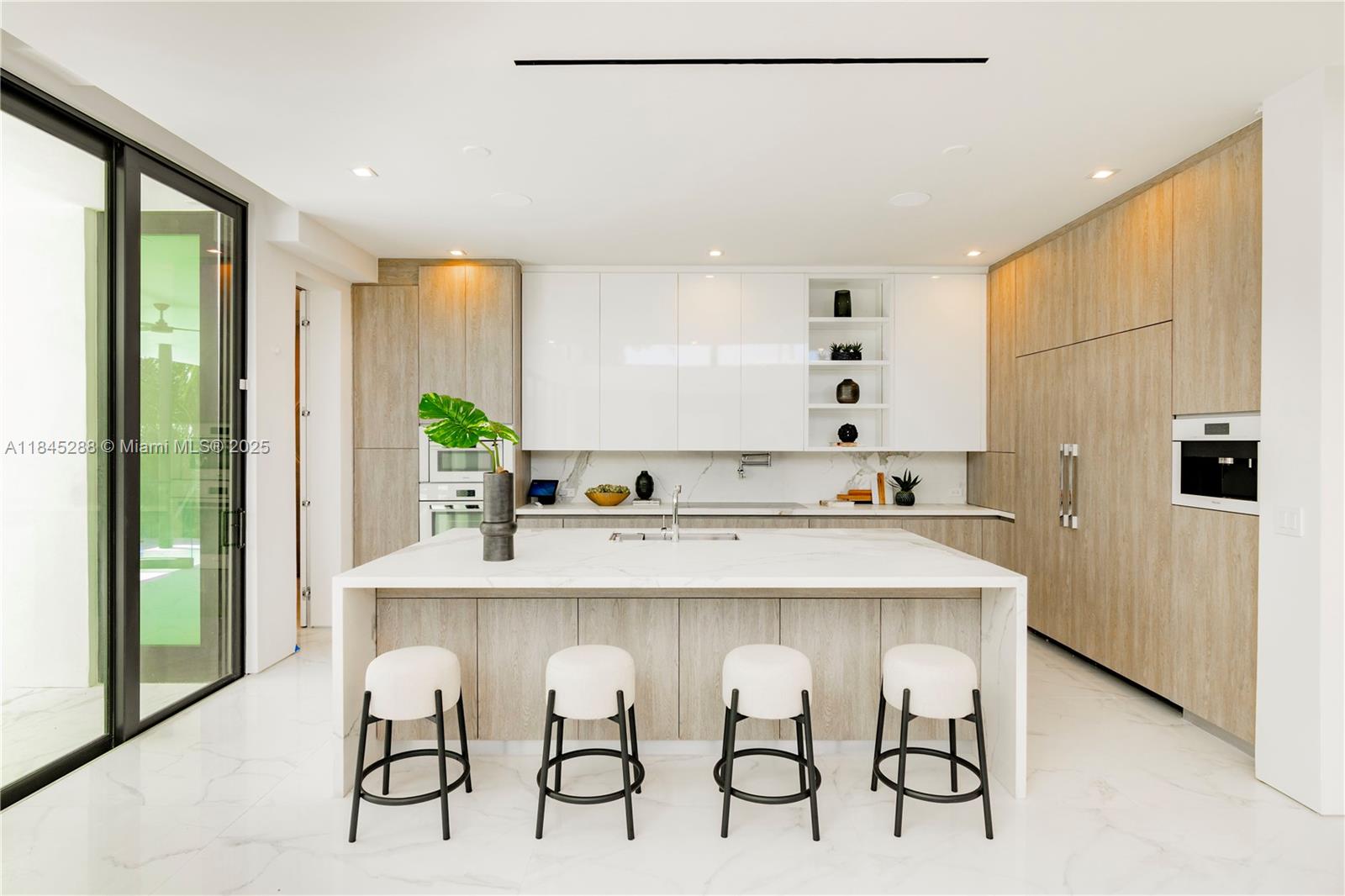 1248 Northeast 89th Street Miami, FL 33138 - Photo 22 of 66 a kitchen with kitchen island a table and chairs in it