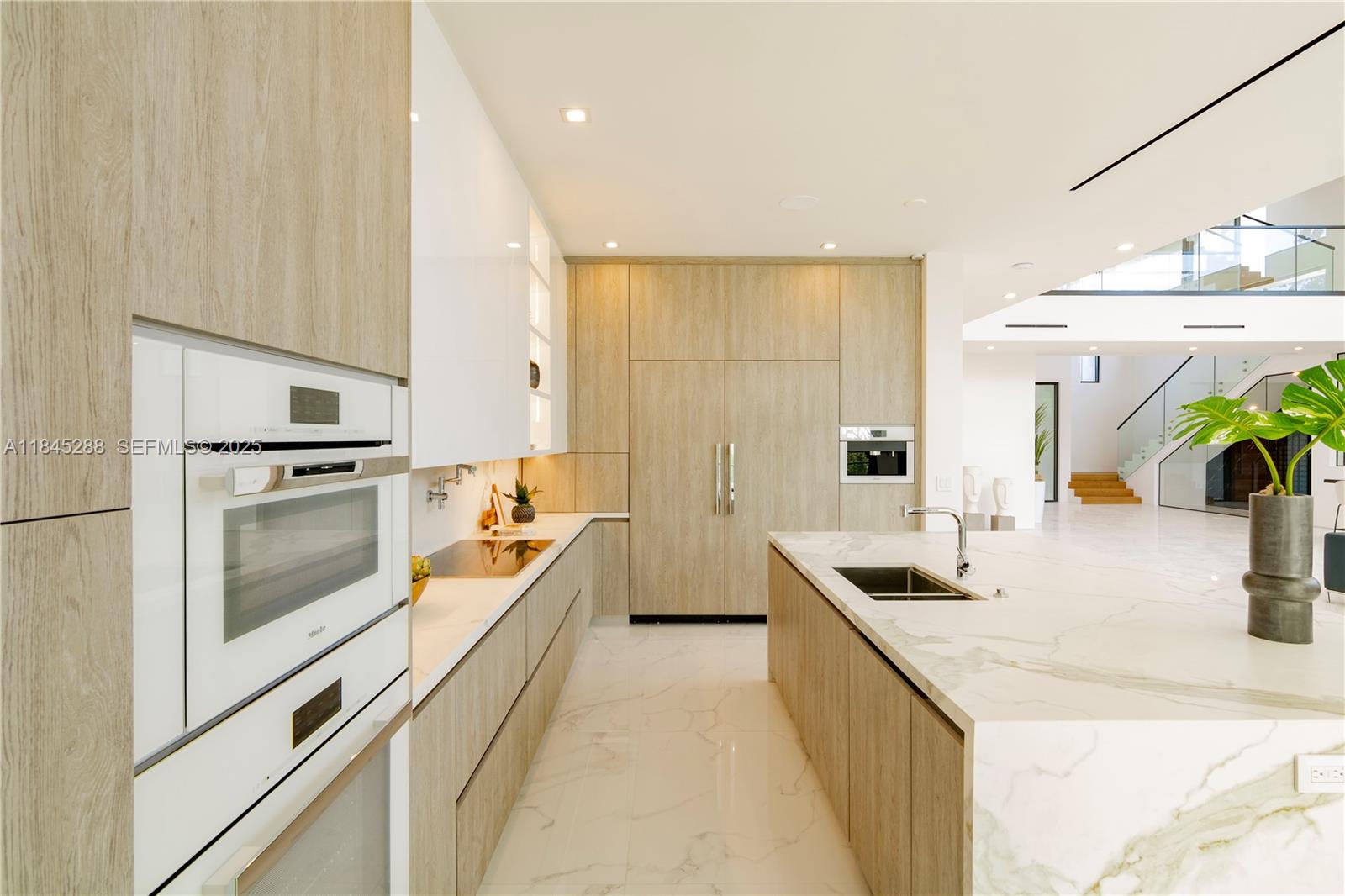 1248 Northeast 89th Street Miami, FL 33138 - Photo 23 of 66 a kitchen with stainless steel appliances granite countertop a sink and a refrigerator