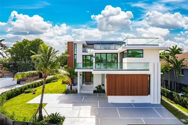 a view of a house with backyard porch and sitting area