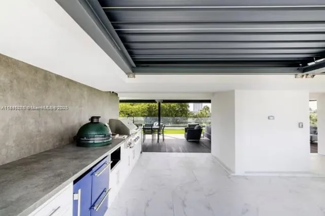 a kitchen with stainless steel appliances a stove and white cabinets