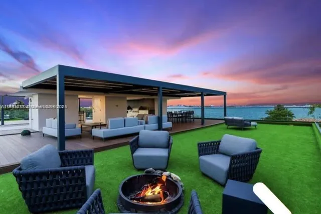a view of a house with backyard porch and sitting area