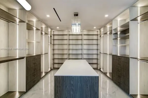 a kitchen with stainless steel appliances kitchen island granite countertop a stove a sink and a microwave