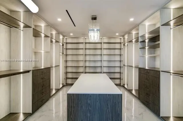 a kitchen with stainless steel appliances kitchen island granite countertop a stove a sink and a microwave