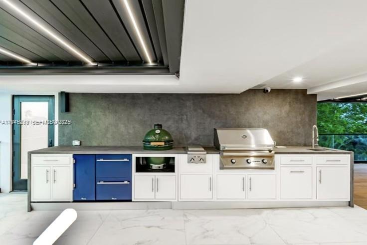 1248 Northeast 89th Street Miami, FL 33138 - Photo 45 of 66 a kitchen with stainless steel appliances a stove and white cabinets