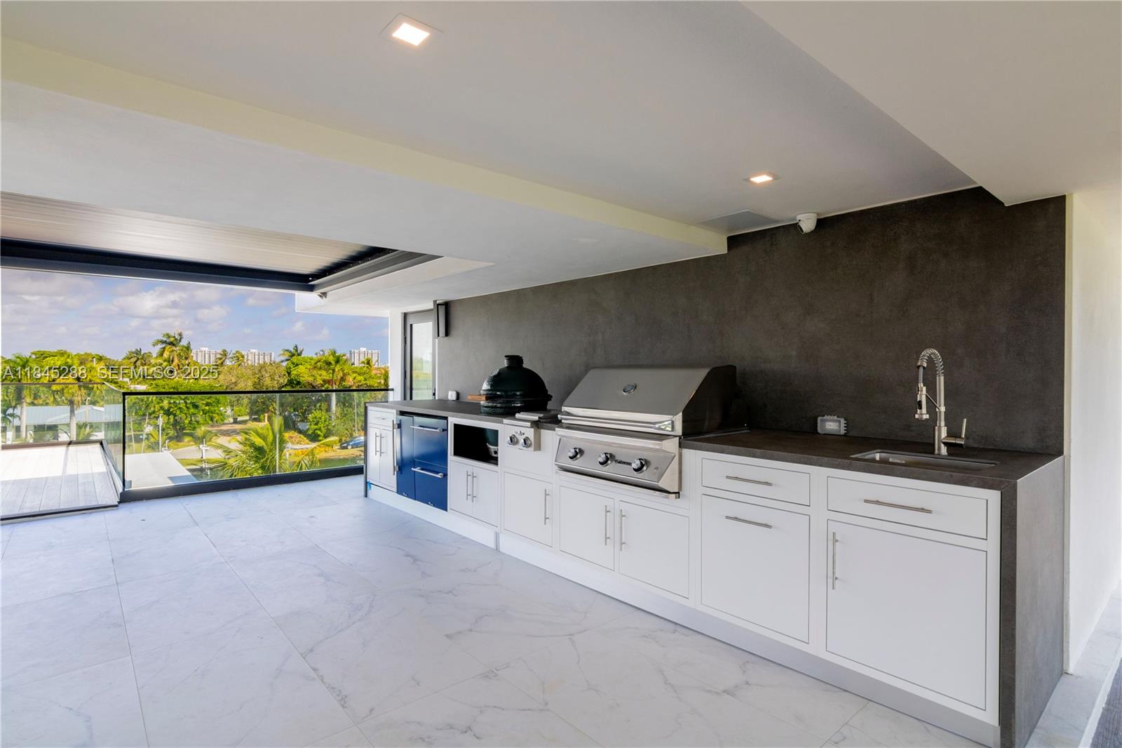 1248 Northeast 89th Street Miami, FL 33138 - Photo 55 of 66 a kitchen with stainless steel appliances kitchen island granite countertop a stove a sink and a microwave