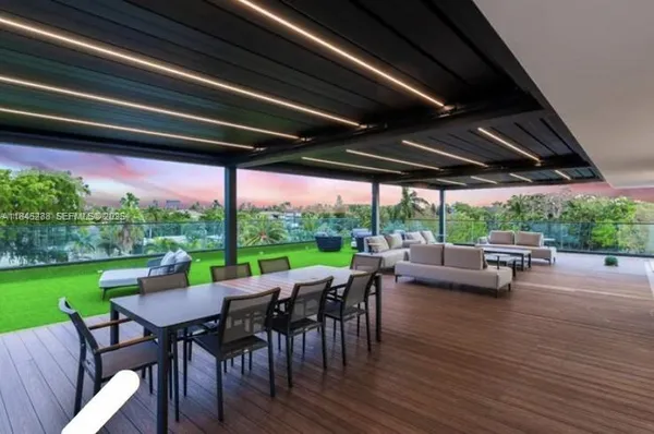 a view of a porch with furniture and a yard
