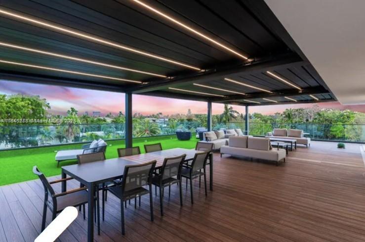 1248 Northeast 89th Street Miami, FL 33138 - Photo 9 of 66 a view of a patio with table and chairs potted plants with wooden floor and fence
