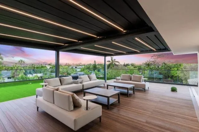 a view of a porch with furniture and a yard