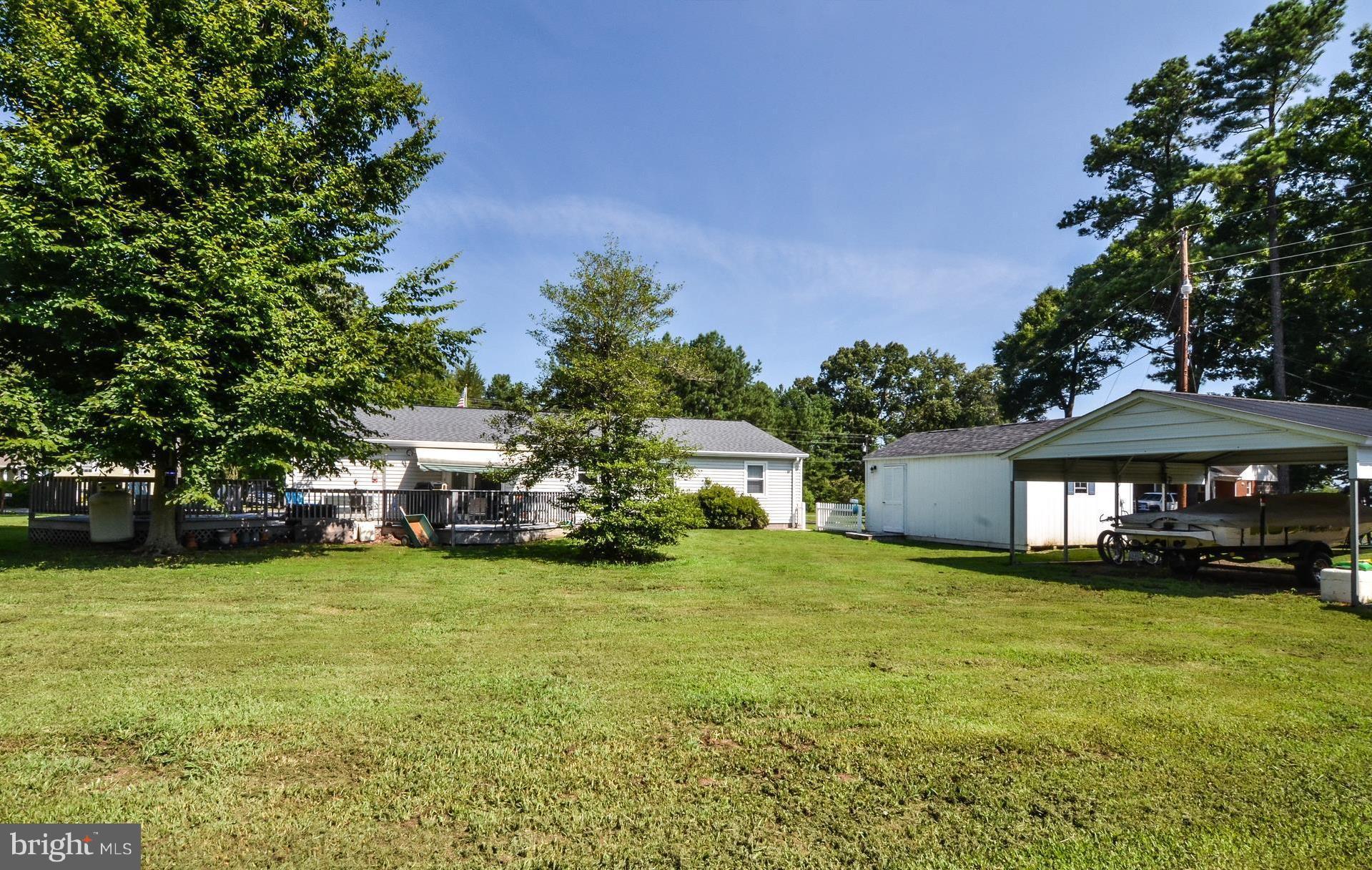 293 Chrystal Road Colonial Beach, VA 22443 - Photo 22 of 26 Boatport, Shed/Garage, Backyard View towards house
