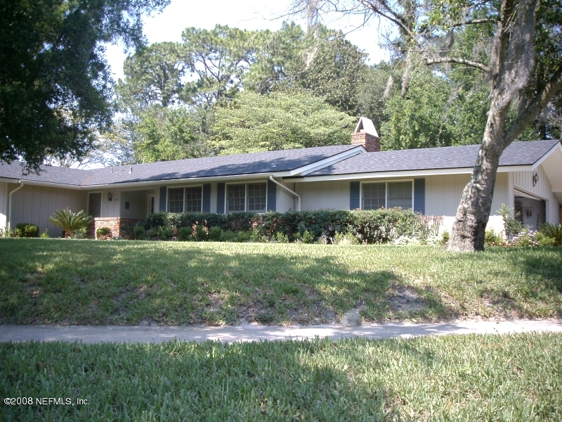 7843 Holiday Road South Jacksonville, FL 32216 - Photo 1 of 13 a front view of a house with a yard