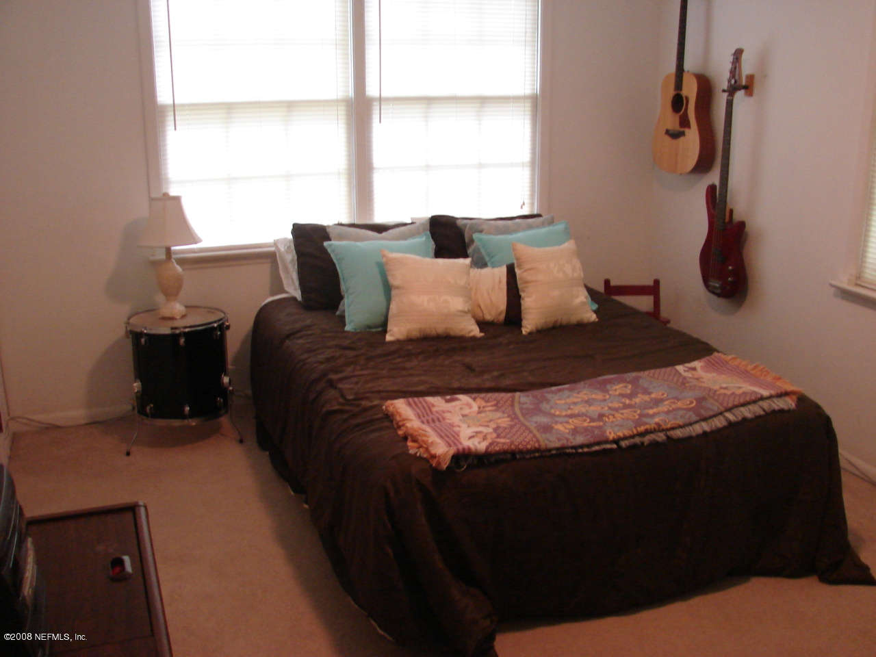 7843 Holiday Road South Jacksonville, FL 32216 - Photo 11 of 13 a large bed sitting in a bedroom next to a window
