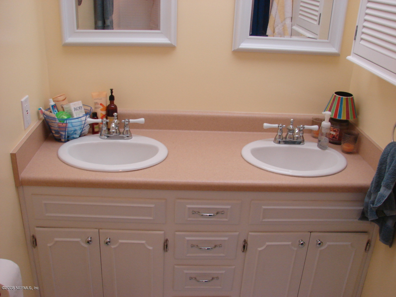7843 Holiday Road South Jacksonville, FL 32216 - Photo 13 of 13 a bathroom with a double vanity sink and a mirror