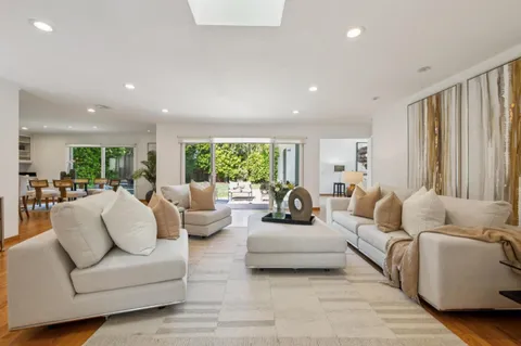 a living room with furniture potted plant and a window