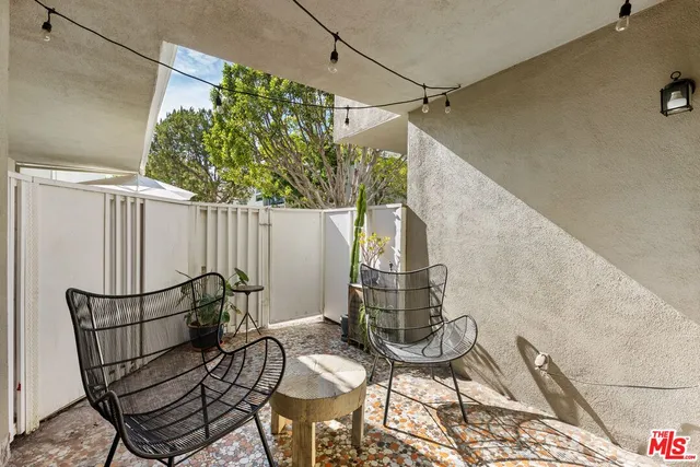 a bedroom with two beds and potted plant
