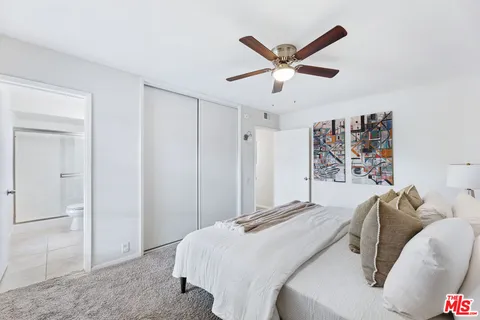 a bathroom with a sink a mirror a toilet and shower