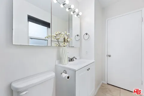a room with a dresser and book shelf