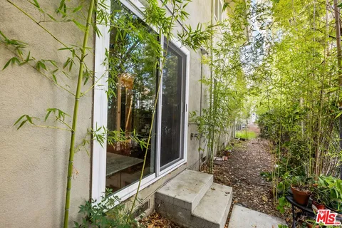 a view of a house with swimming pool and sitting area