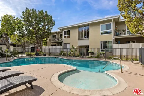 a view of a house with backyard porch and sitting area