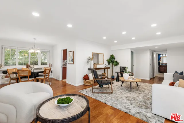 a living room with furniture a rug and a large window