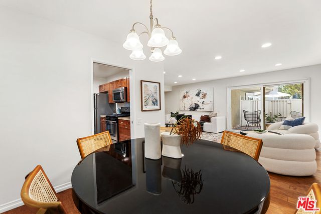 a living room with furniture a chandelier and a dining room
