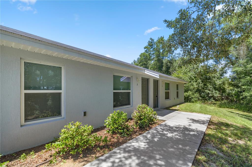 32 Pine Track, Unit 3 Ocala, FL 34472 - Photo 1 of 1 a front view of a house with garden