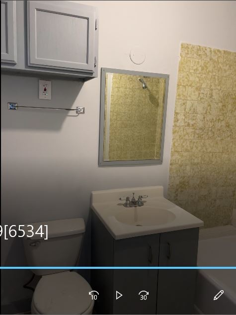 1237 West Marquette Road, Unit 1W Chicago, IL 60636 - Photo 9 of 9 a bathroom with a sink and a mirror