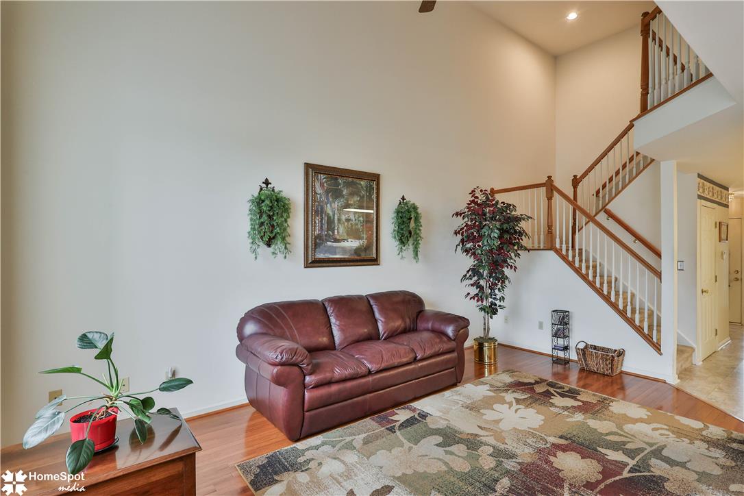 507 Howertown Road Northampton, PA 18067 - Photo 13 of 46 A striking two-story living area features rich hardwood flooring and a prominent staircase.