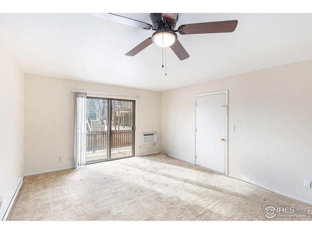 806 Stone Mountain Drive, Unit 103 Windsor, CO 80550 - Photo 3 of 10 a view of an empty room with a window
