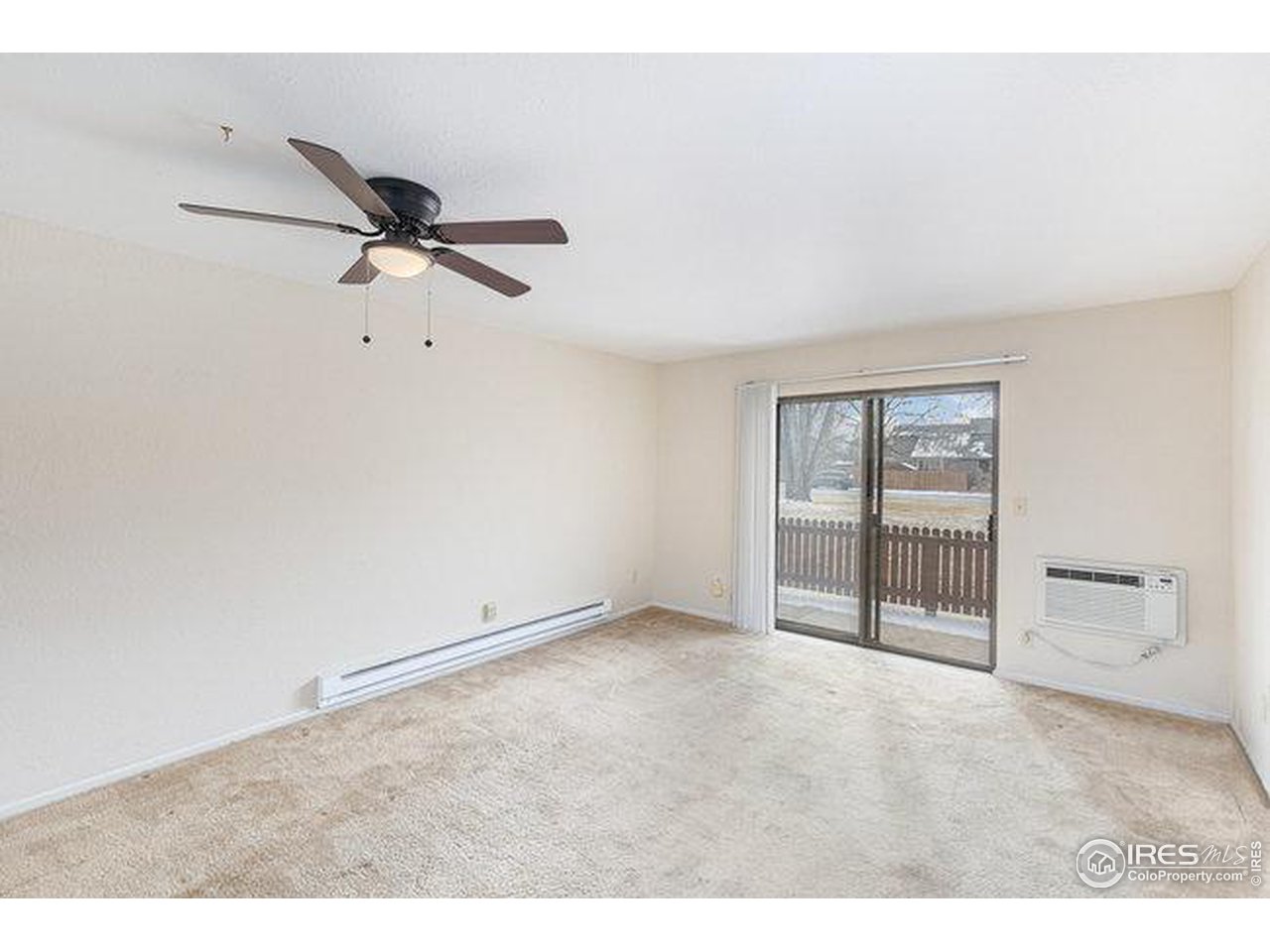 806 Stone Mountain Drive, Unit 103 Windsor, CO 80550 - Photo 4 of 10 a view of an empty room with a window