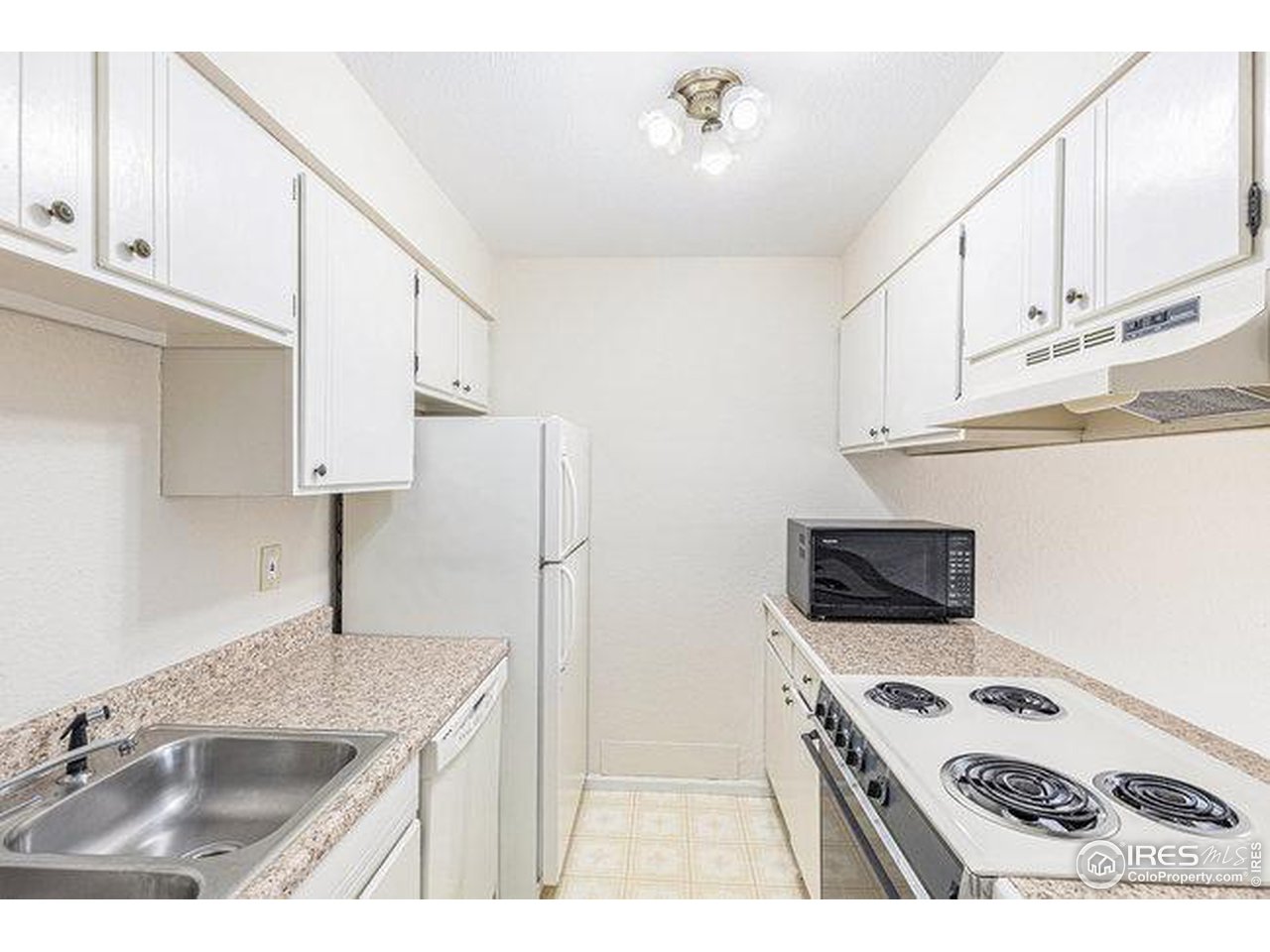 806 Stone Mountain Drive, Unit 103 Windsor, CO 80550 - Photo 6 of 10 a kitchen with stainless steel appliances granite countertop a sink stove and refrigerator
