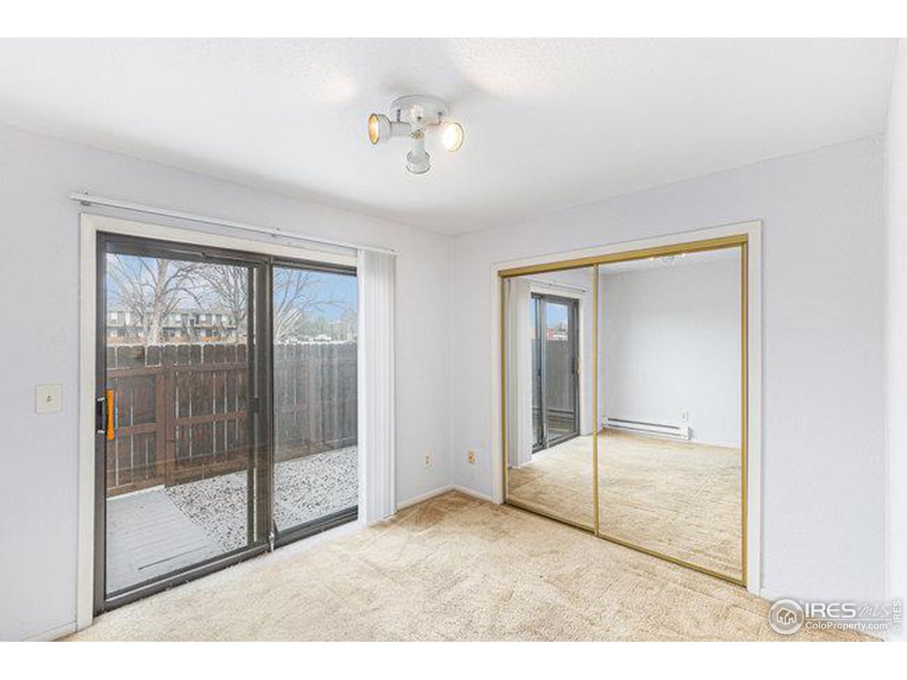 806 Stone Mountain Drive, Unit 103 Windsor, CO 80550 - Photo 9 of 10 a view of empty room with wooden floor