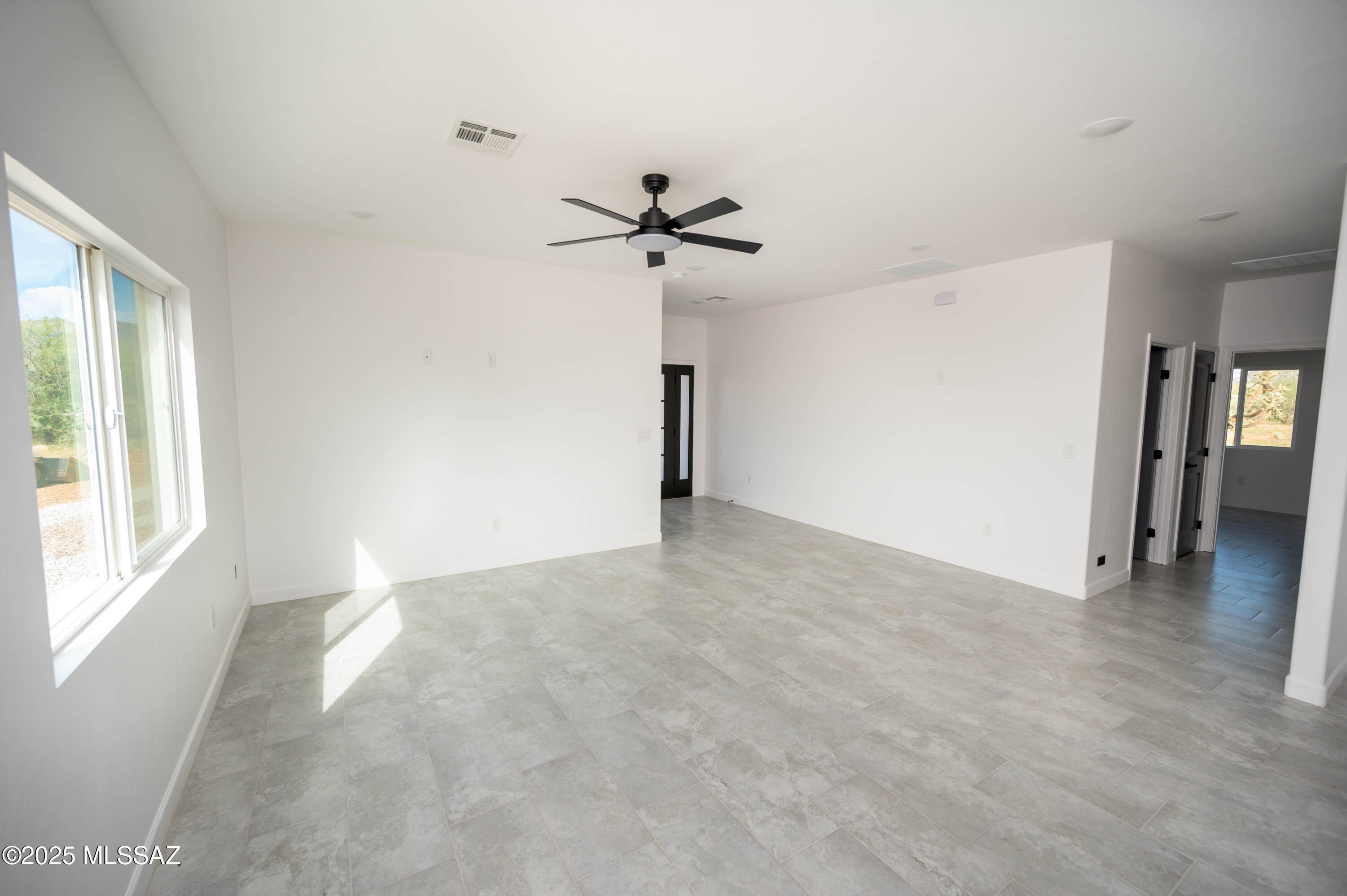 1781 Elder Court Rio Rico, AZ 85648 - Photo 37 of 50 wooden floor in an empty room with a window
