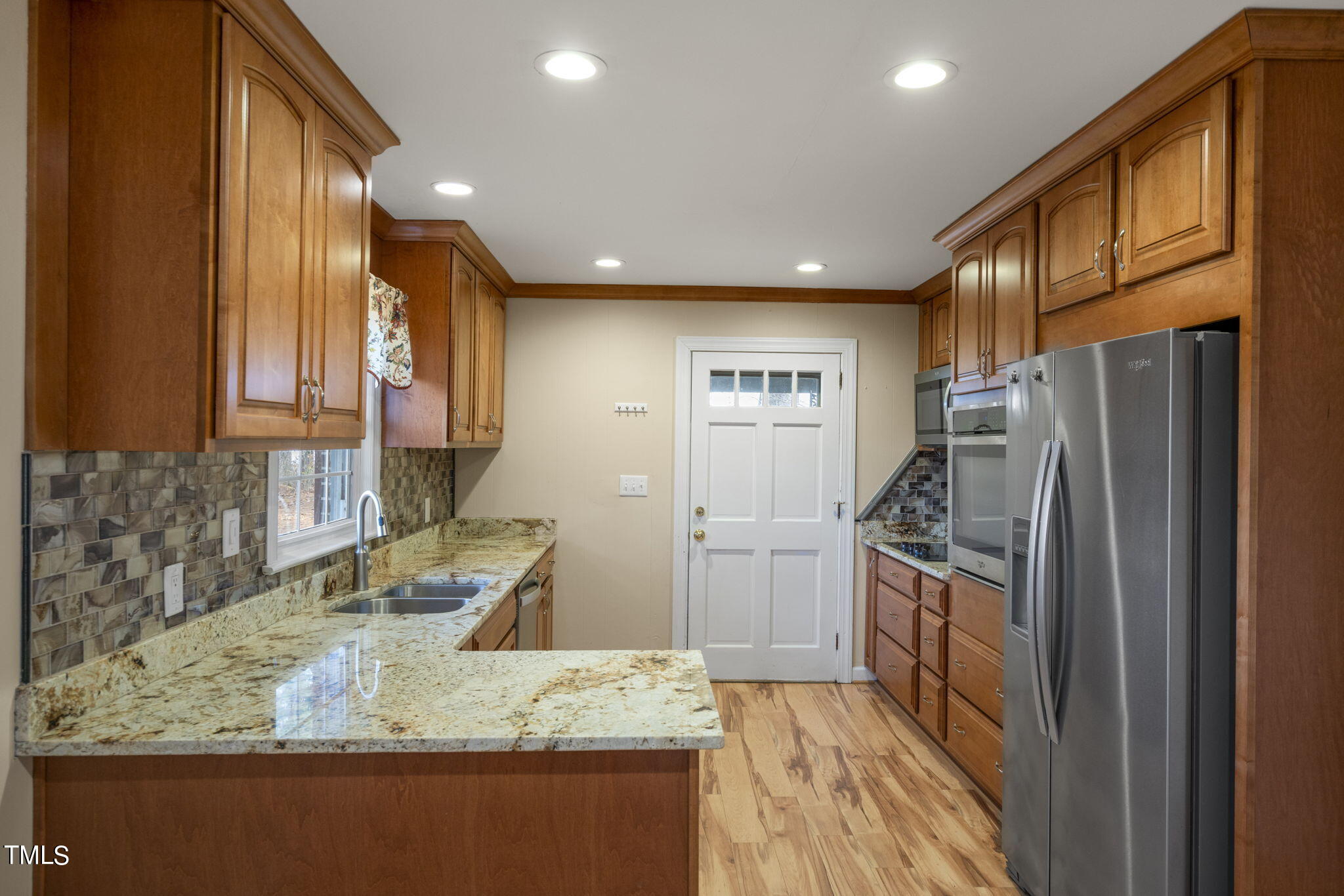 13573 Old Smithfield Road Sims, NC 27880 - Photo 12 of 33 a kitchen with granite countertop a refrigerator and a sink