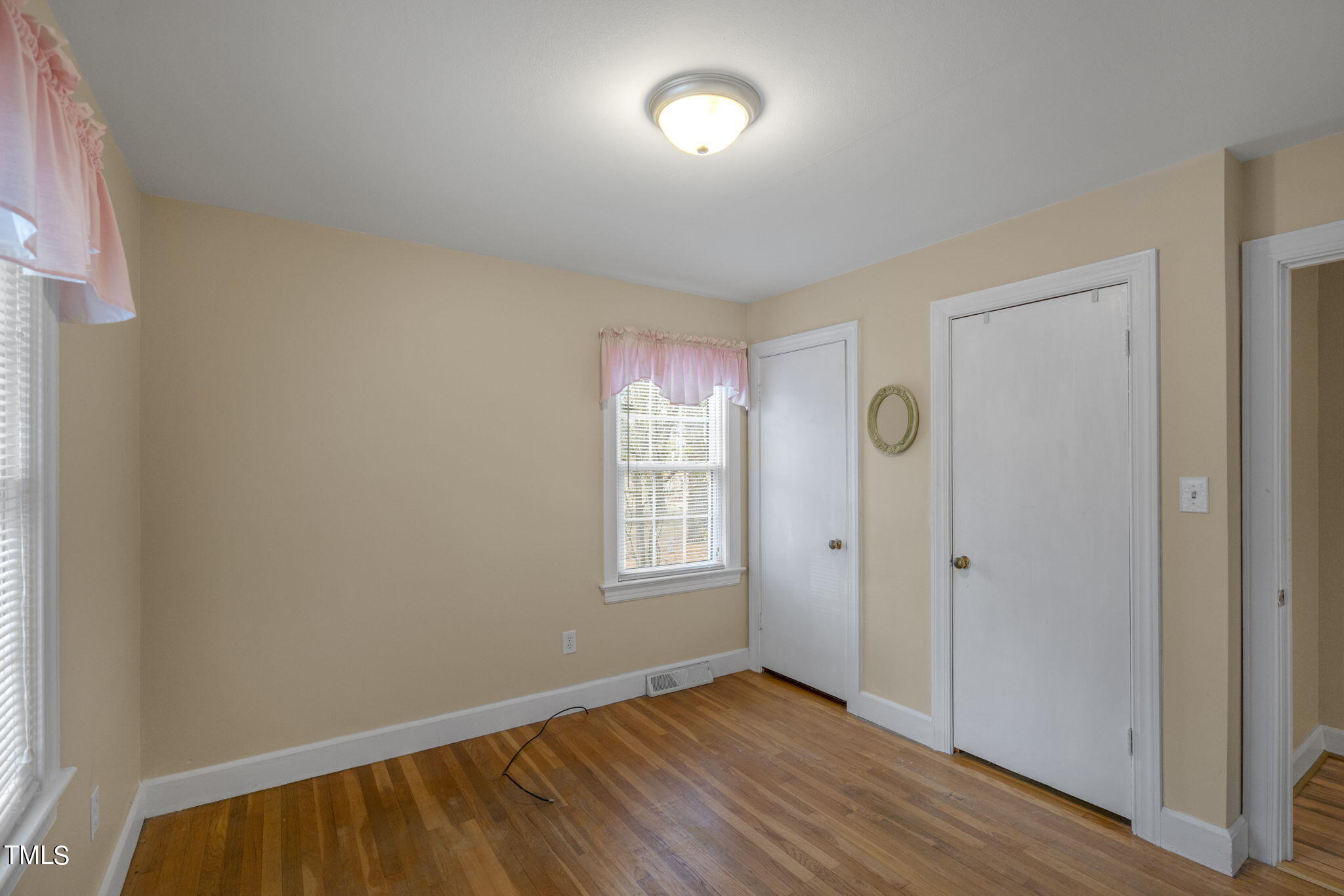 13573 Old Smithfield Road Sims, NC 27880 - Photo 18 of 33 an empty room with wooden floor and windows