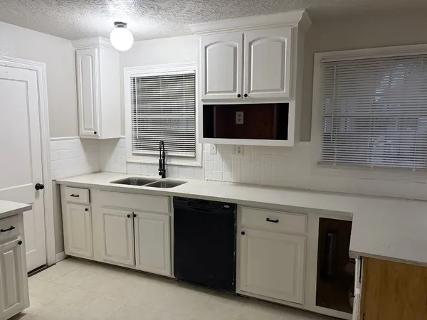 a kitchen with stainless steel appliances granite countertop a sink a stove and microwave