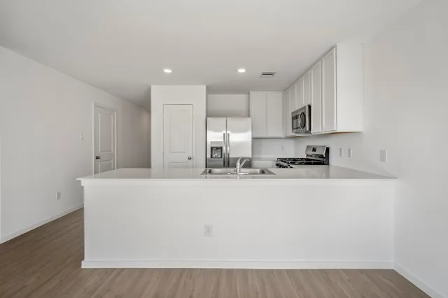 a view of kitchen with kitchen island stainless steel appliances sink and stove
