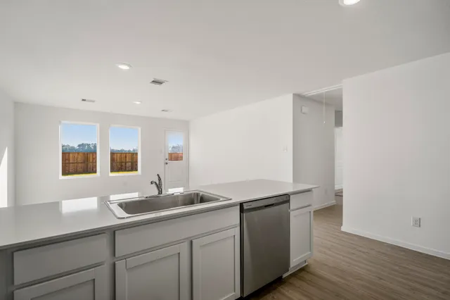 a kitchen with a sink and a mirror