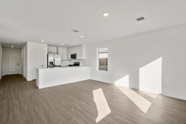 a view of kitchen with cabinets and wooden floor