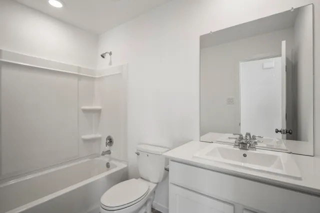 a bathroom with a sink toilet vanity and shower