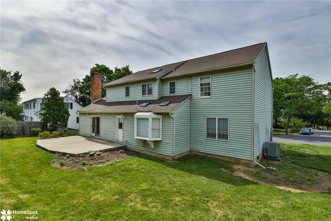 4059 Wedgewood Road Allentown, PA 18104 - Photo 71 of 72 Green siding exterior with a concrete patio overlooking a manicured lawn.