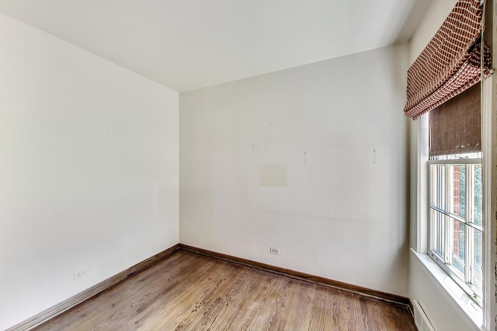 580 North Happ Road Northfield, IL 60093 - Photo 11 of 49 a view of an empty room with wooden floor and a window