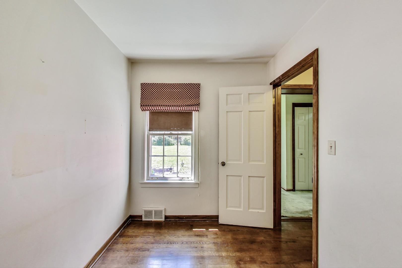 580 North Happ Road Northfield, IL 60093 - Photo 12 of 49 an empty room with wooden floor closet and windows