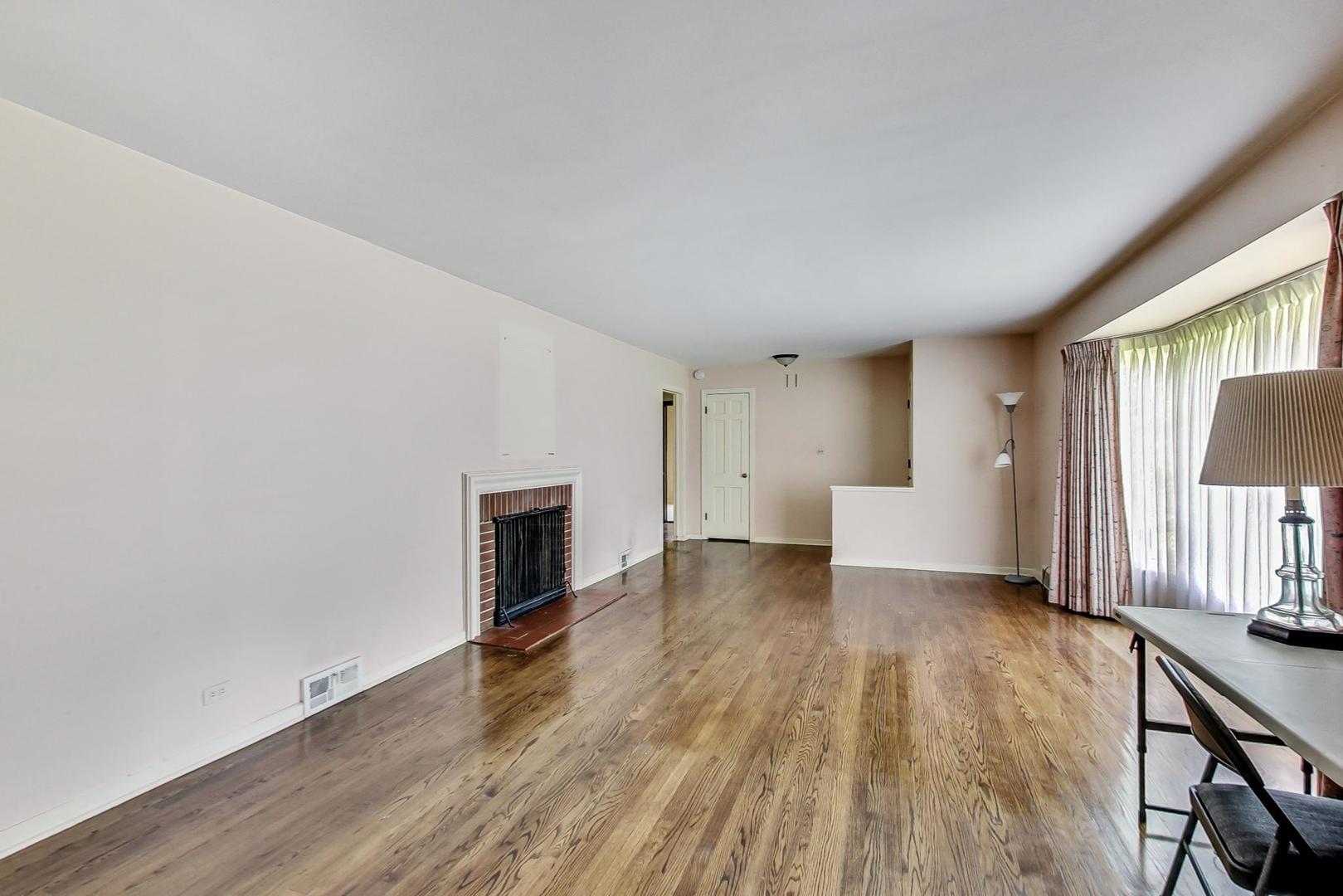 580 North Happ Road Northfield, IL 60093 - Photo 25 of 49 a view of empty room with wooden floor and fireplace
