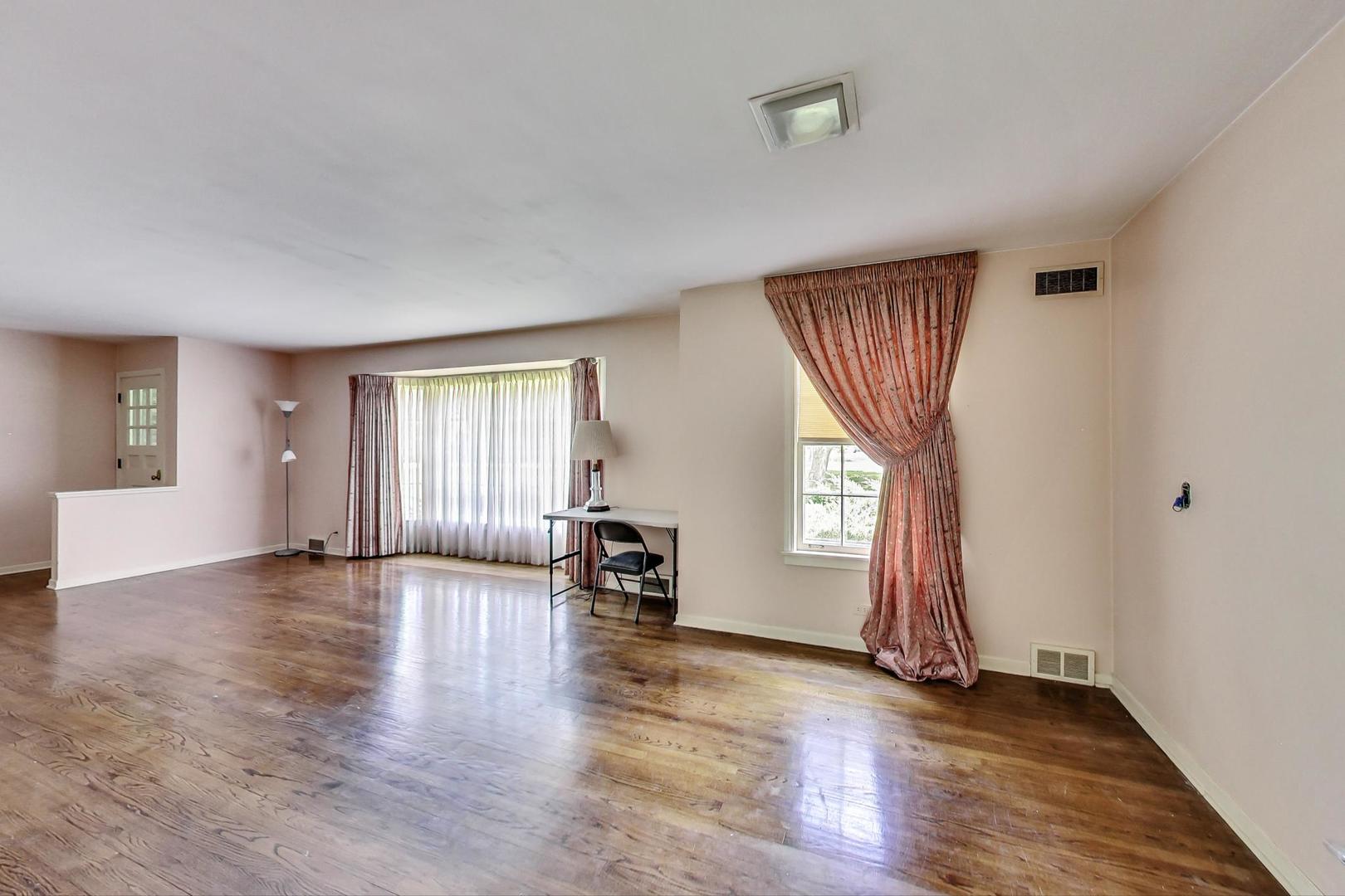 580 North Happ Road Northfield, IL 60093 - Photo 4 of 49 an empty room with wooden floor and windows